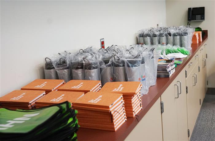 A table filled with giveaway materials.